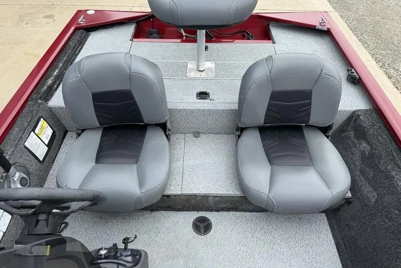 Slide: The Image of 2019 Tracker Pro 170 boat interior with two gray seats and steering console. - 12