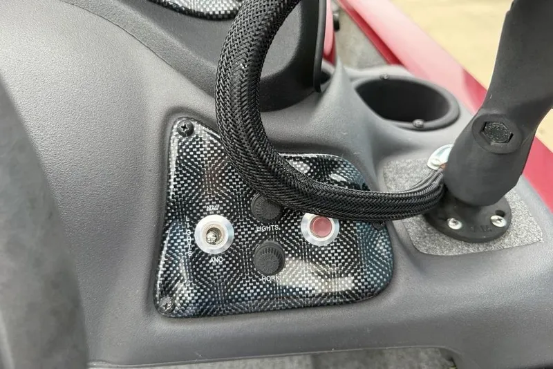 Slide: The Image of Control panel of a 2019 Tracker Pro 170 boat with switches and cup holder. - 18