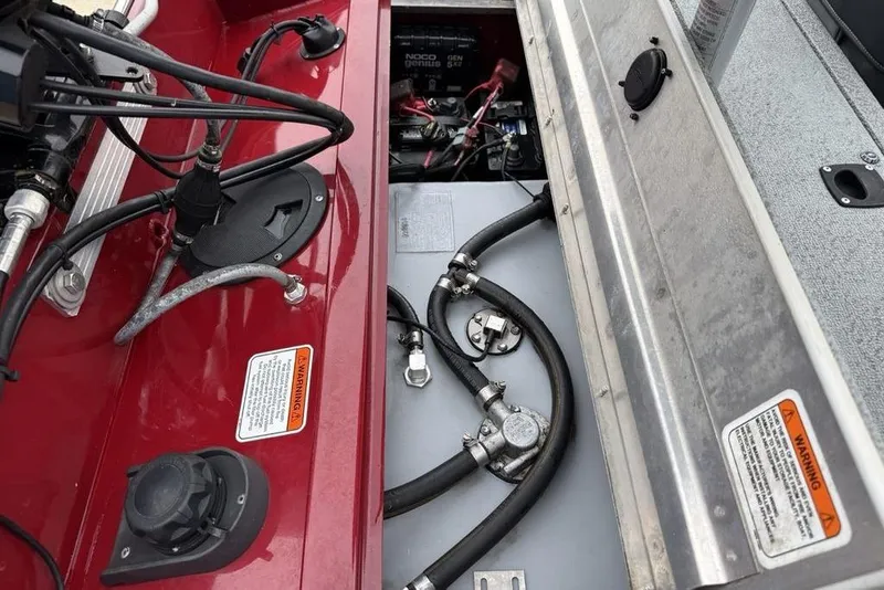 Slide: The Image of 2019 Tracker Pro 170 boat engine compartment with wiring and fuel lines. - 22