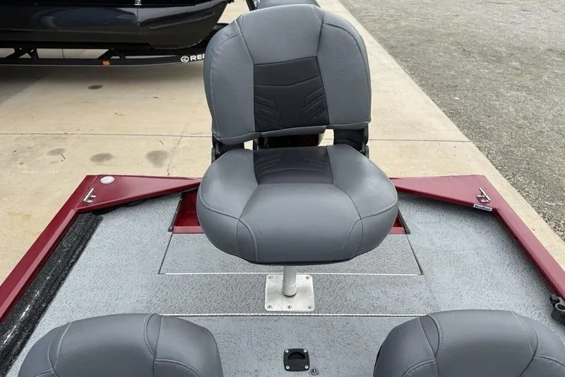 Slide: The Image of 2019 Tracker Pro 170 boat seat with gray upholstery on a red deck. - 23