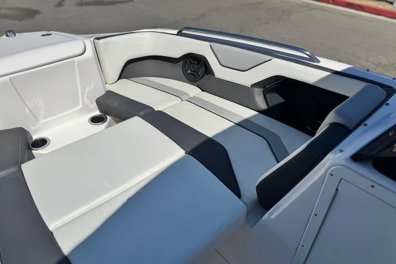 Slide: The Image of 2022 Yamaha Boats 212 interior with sleek, modern seating and cup holders. - 11