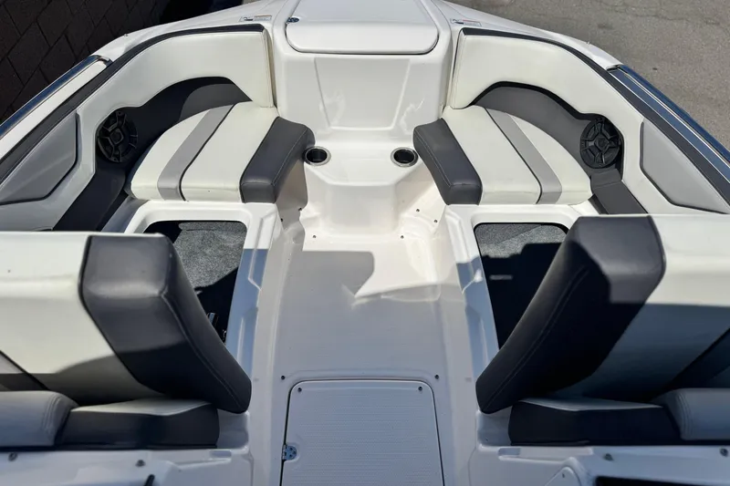 Slide: The Image of 2022 Yamaha Boats 212 interior with sleek seating and cup holders. - 12