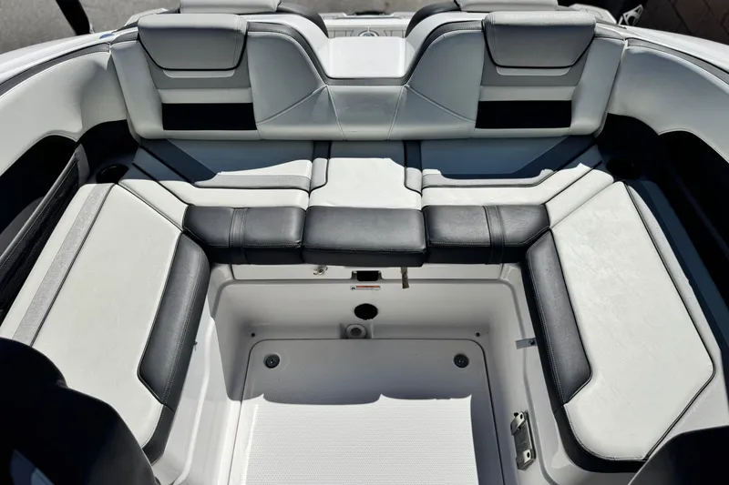 Slide: The Image of 2022 Yamaha Boats 212 interior seating with black and white upholstery. - 16