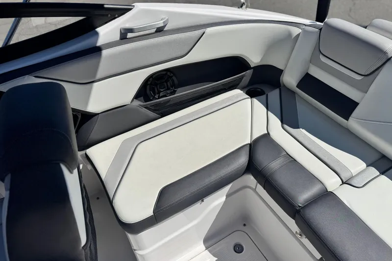 Slide: The Image of 2022 Yamaha Boats 212 interior seating with sleek, modern design and comfortable upholstery. - 17