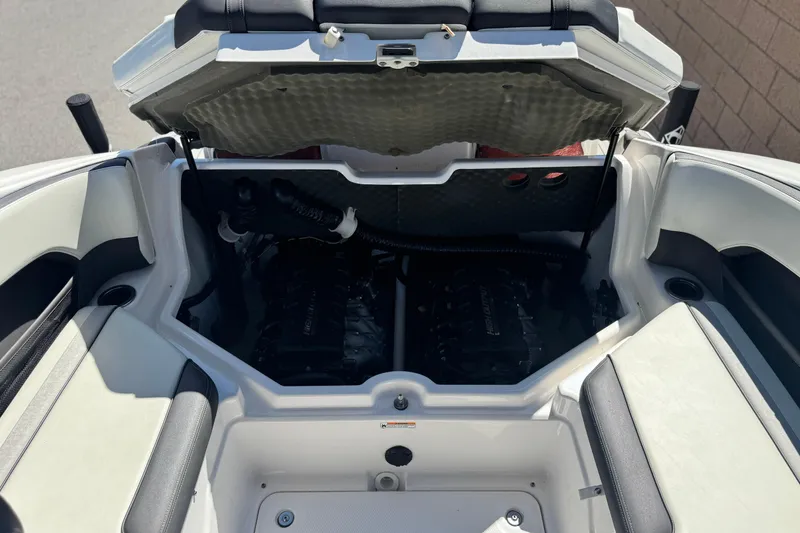Slide: The Image of 2022 Yamaha Boats 212 engine compartment with open hatch, showcasing dual engines. - 19