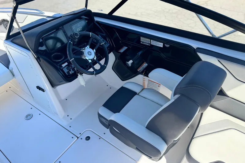 Slide: The Image of 2022 Yamaha Boats 212 cockpit with steering wheel and modern dashboard controls. - 24