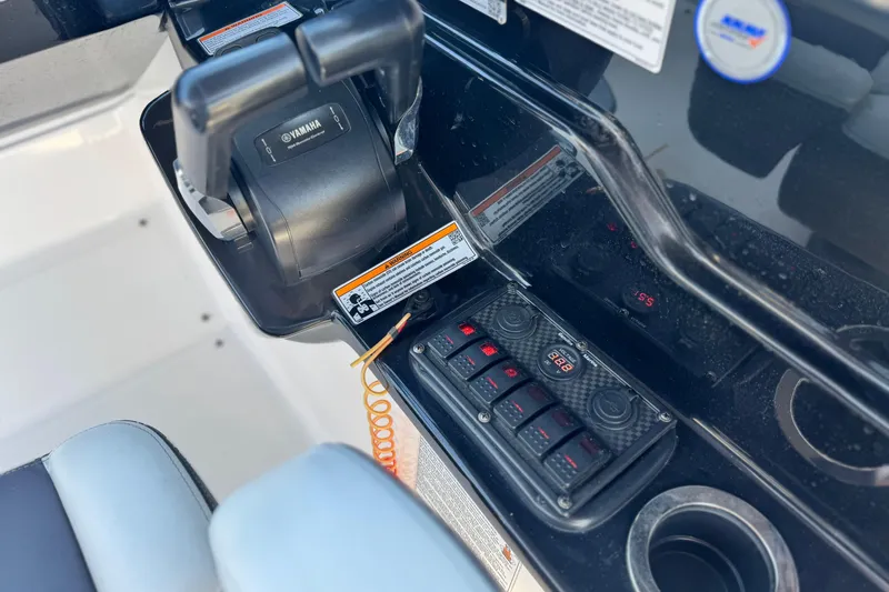 Slide: The Image of Control panel of 2022 Yamaha Boats 212, featuring throttle and switches. - 26