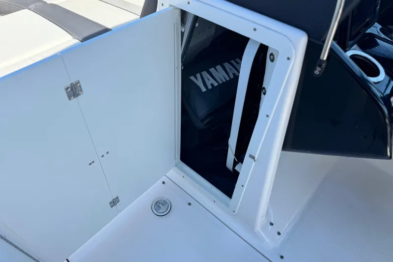 Slide: The Image of Open storage compartment on 2022 Yamaha Boats 212, showcasing interior space and design. - 32