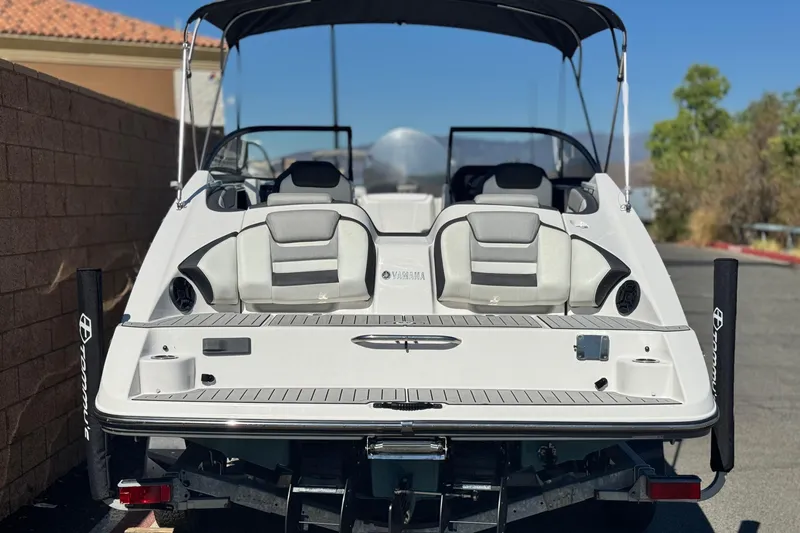 Slide: The Image of 2022 Yamaha Boats 212, rear view, showcasing seating and deck features. - 4