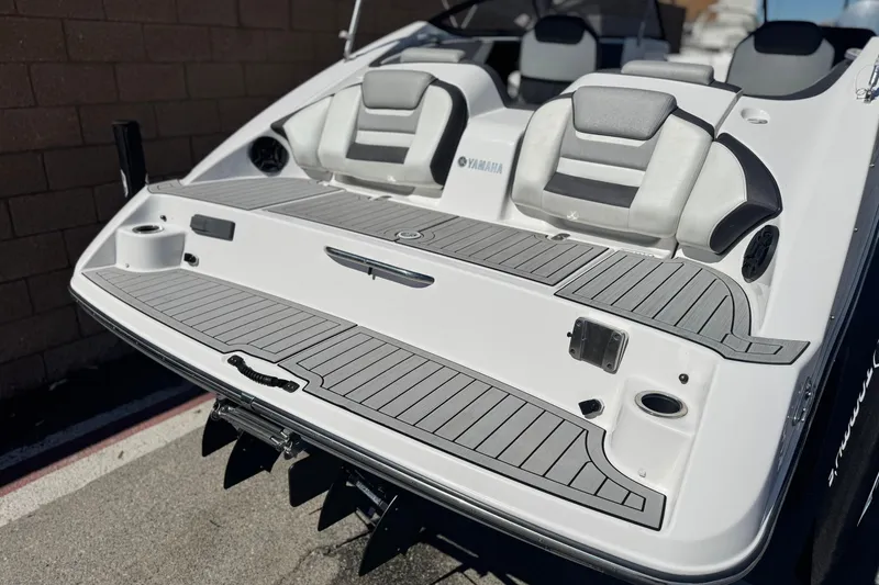 Slide: The Image of 2022 Yamaha Boats 212 rear view, featuring sleek seating and modern design. - 6