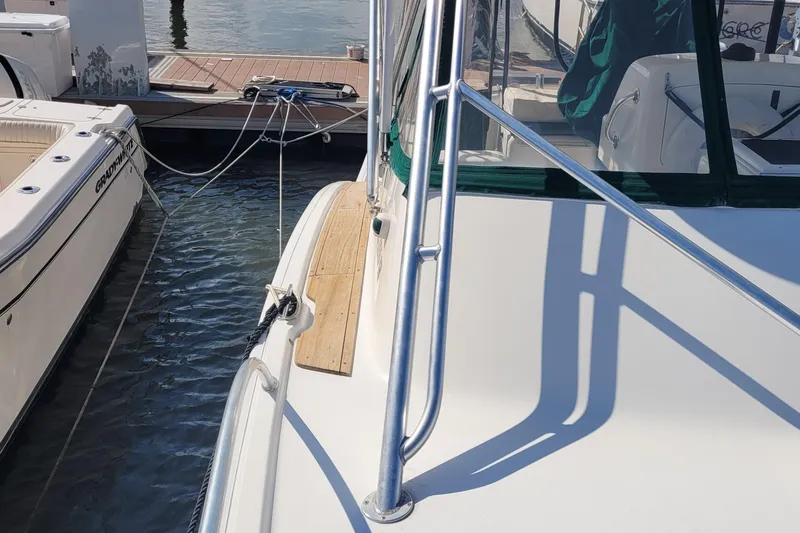 Slide: The Image of 2002 SeaTek 36 Express yacht docked beside another boat at a marina. - 31