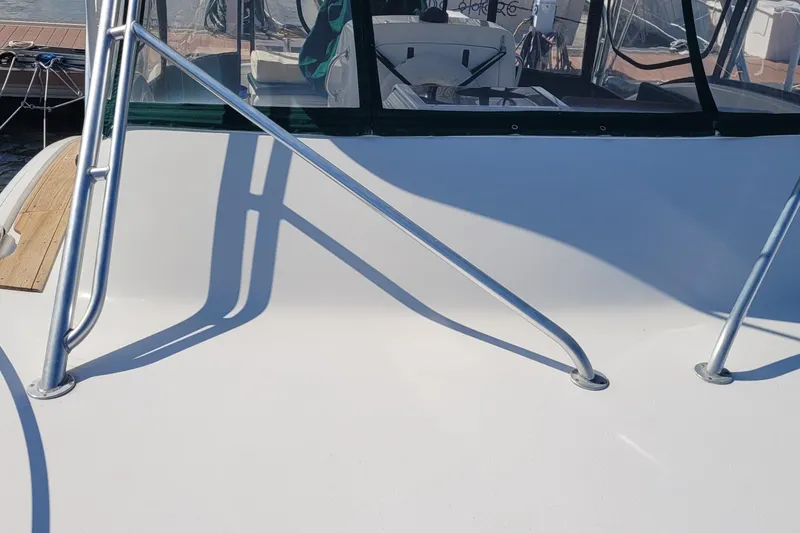 Slide: The Image of 2002 SeaTek 36 Express boat deck with metal railings and cockpit view. - 32