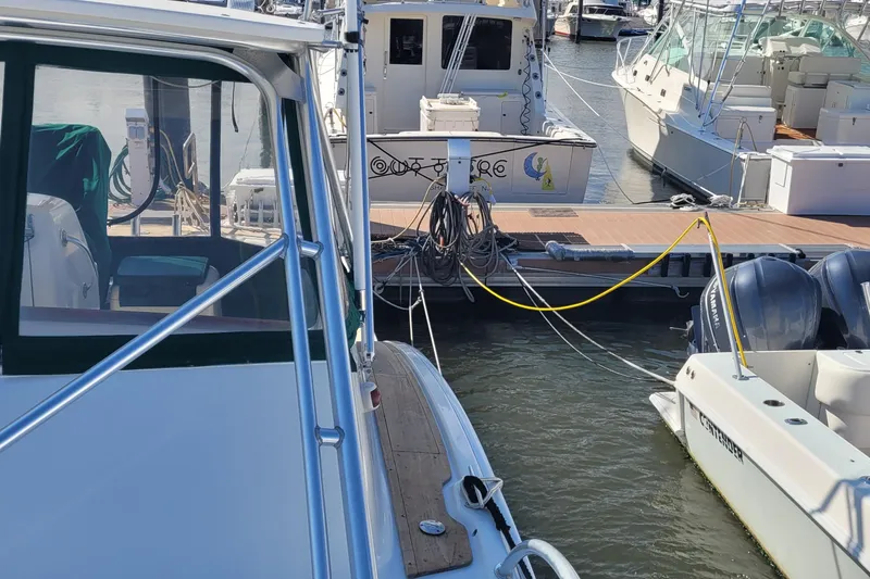 Slide: The Image of 2002 SeaTek 36 Express docked at marina with other boats. - 36