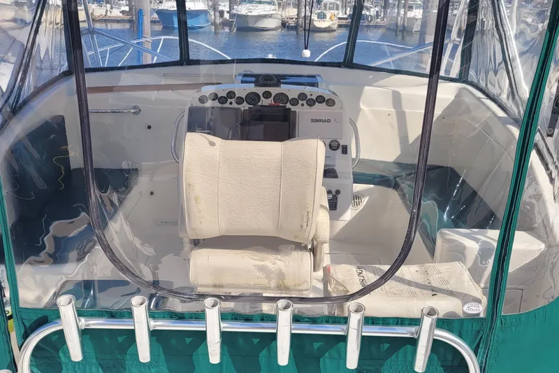 Slide: The Image of Cockpit of 2002 SeaTek 36 Express boat with helm and seating at marina. - 37