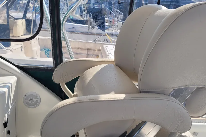 Slide: The Image of Luxurious seating on 2002 SeaTek 36 Express boat, featuring elegant white upholstery. - 38