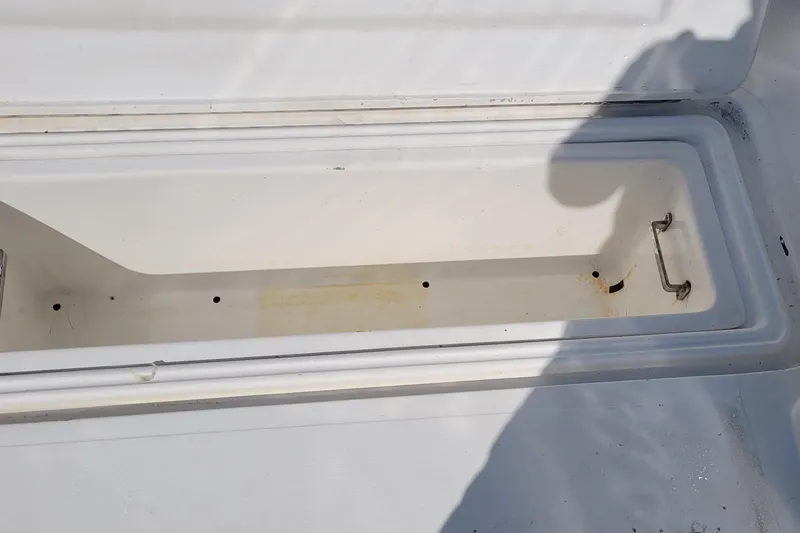 Slide: The Image of Open storage compartment on 2002 SeaTek 36 Express boat, showing interior details. - 43