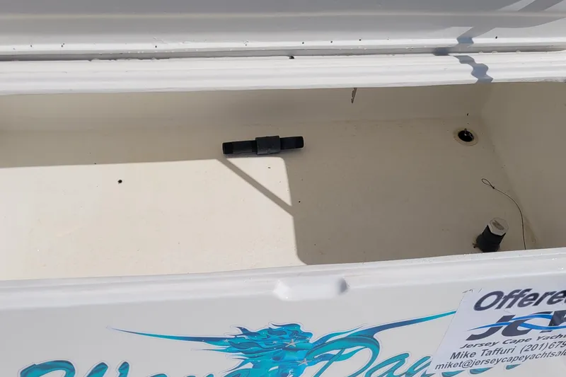 Slide: The Image of Open storage compartment on 2002 SeaTek 36 Express boat, featuring clean interior space. - 47