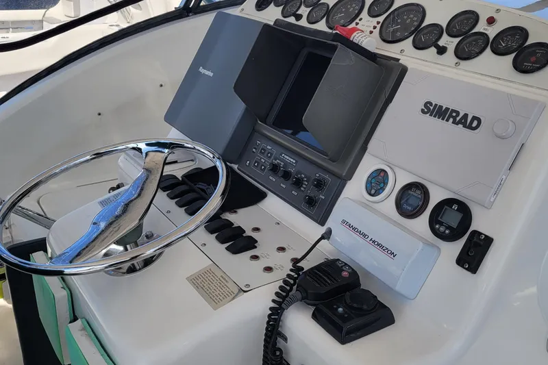 Slide: The Image of Control panel of a 2002 SeaTek 36 Express boat with navigation equipment. - 48