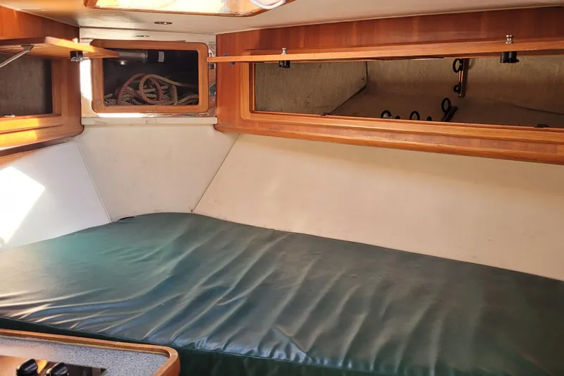 Slide: The Image of Interior cabin of 2002 SeaTek 36 Express boat with wooden storage and green cushion. - 59