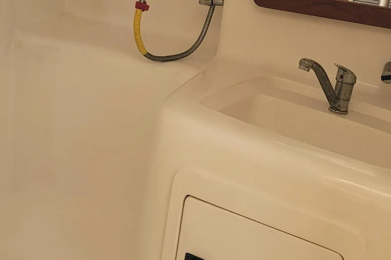 Slide: The Image of Interior of 2002 SeaTek 36 Express boat showing sink and faucet. - 60