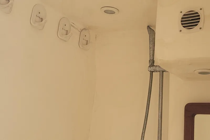 Slide: The Image of Interior of 2002 SeaTek 36 Express boat showing shower area with fixtures. - 61