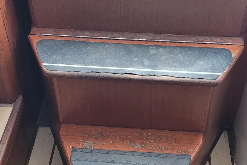 Slide: The Image of Wooden steps with anti-slip strips on a 2002 SeaTek 36 Express boat. - 62