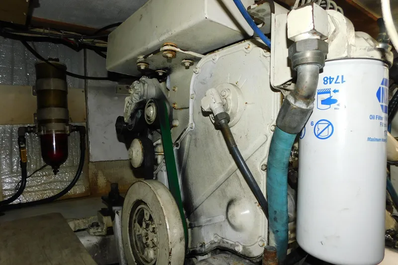 Slide: The Image of Engine compartment of a 2002 SeaTek 36 Express boat, featuring oil filter and hoses. - 63