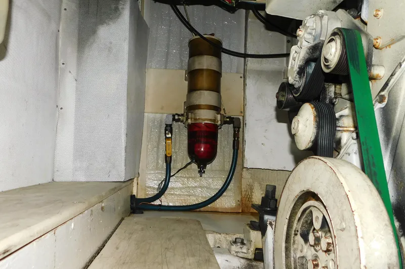 Slide: The Image of Engine compartment of a 2002 SeaTek 36 Express boat, showing belts and components. - 65