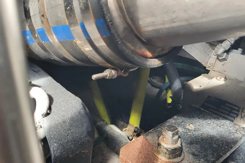 Slide: The Image of Engine compartment of a 2002 SeaTek 36 Express boat, showing pipes and bolts. - 75