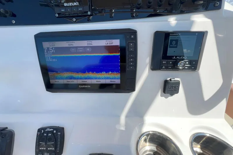 Slide: The Image of Console of 2022 Pioneer 202 Islander with Garmin and JL Audio displays. - 11