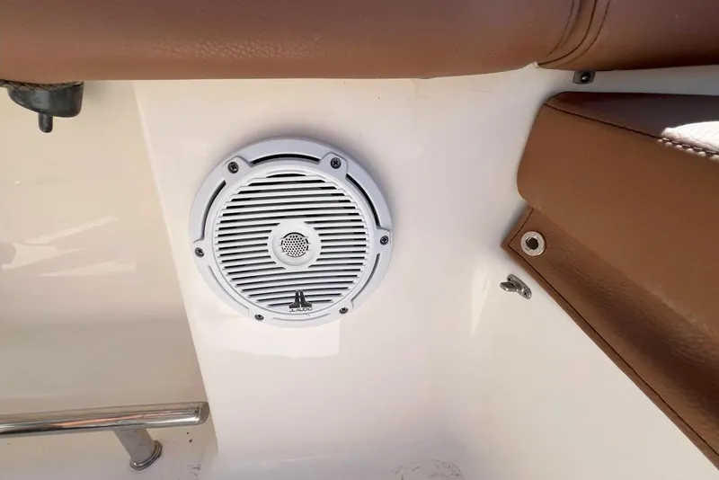 Slide: The Image of White speaker on 2022 Pioneer 202 Islander boat with brown leather seating. - 12