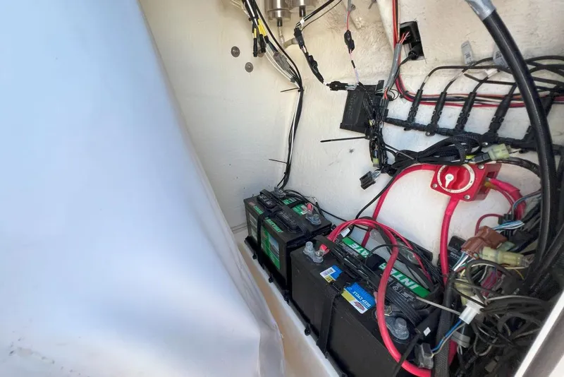 Slide: The Image of Battery compartment of 2022 Pioneer 202 Islander boat with wiring and connections. - 14