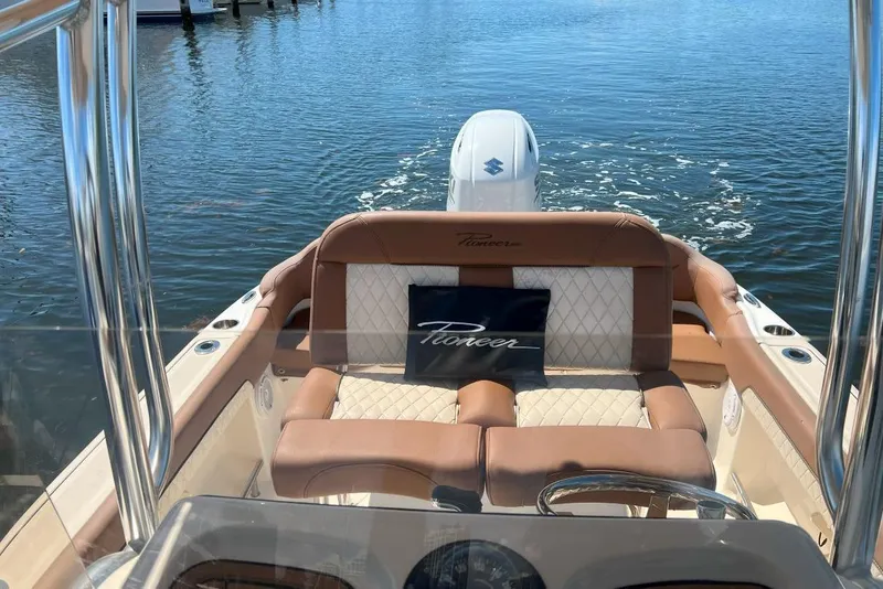 Slide: The Image of 2022 Pioneer 202 Islander boat interior with tan seating on calm water. - 3