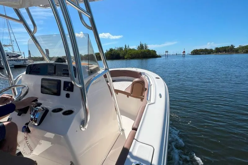 Slide: The Image of 2022 Pioneer 202 Islander boat cruising on a sunny day in calm waters. - 4