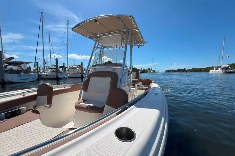 Slide: The Image of 2022 Pioneer 202 Islander boat docked in a marina under clear blue skies. - 9
