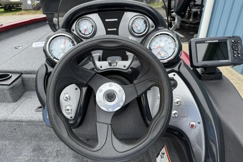 Slide: The Image of 2024 Tracker Pro Team 175 TXW® boat dashboard with steering wheel and gauges. - 8