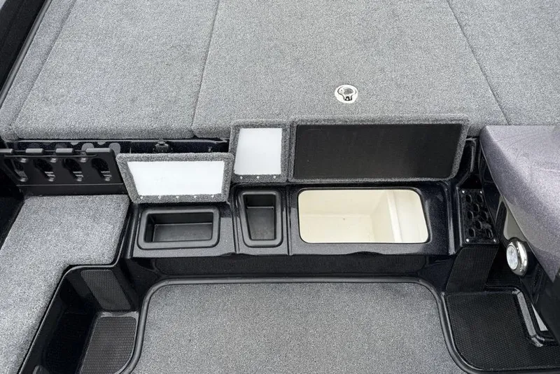 Slide: The Image of 2019 Phoenix 921 PRO XP boat storage compartments with gray carpeted interior. - 12