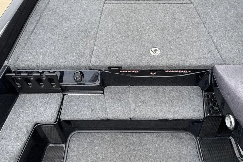 Slide: The Image of 2019 Phoenix 921 PRO XP boat interior with gray carpet and storage compartments. - 13