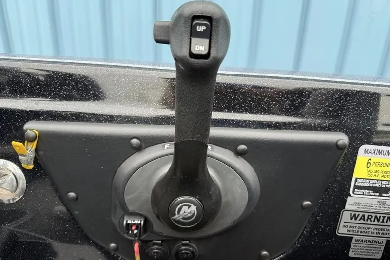 Slide: The Image of Control panel of a 2019 Phoenix 921 PRO XP boat with throttle lever and warning labels. - 19