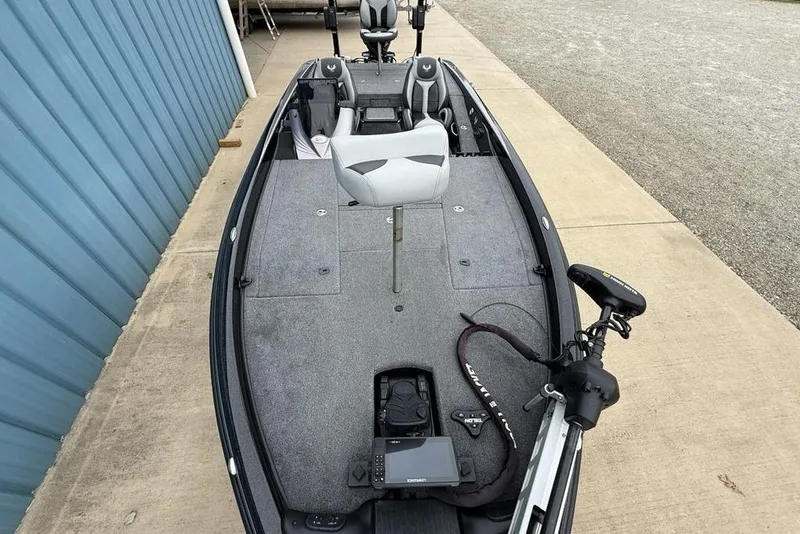 Slide: The Image of 2019 Phoenix 921 PRO XP fishing boat with seating and equipment, parked on concrete. - 24