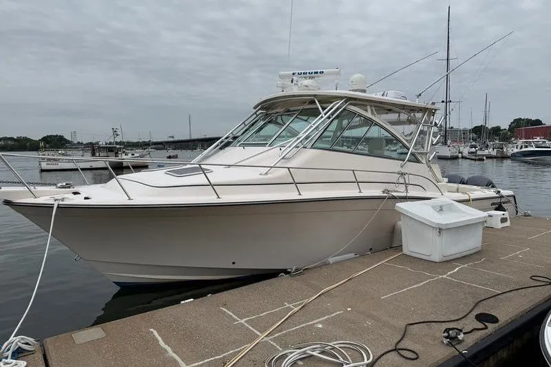 The Image of 2008 Grady-White Express 360 boat docked at marina under cloudy sky. - 1