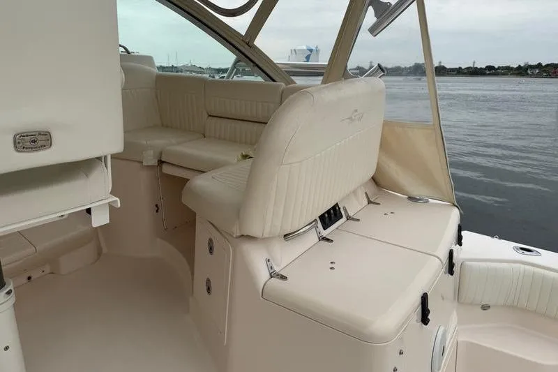 Slide: The Image of 2008 Grady-White Express 360 boat interior with cream seating and water view. - 10