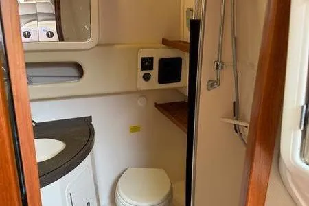 Slide: The Image of 2008 Grady-White Express 360 boat bathroom interior with sink, toilet, and shower. - 12