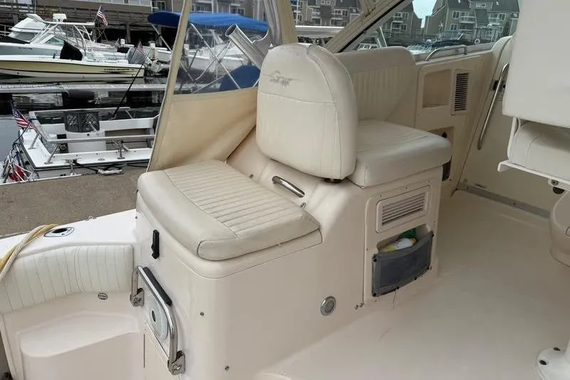 Slide: The Image of 2008 Grady-White Express 360 boat interior with white seating at a marina. - 7