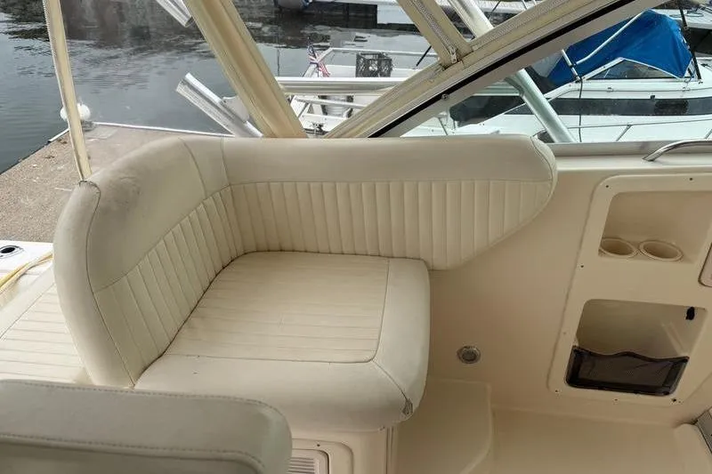 Slide: The Image of 2008 Grady-White Express 360 boat interior with cream seating and cup holders. - 8