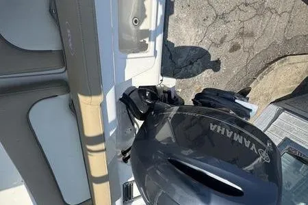 Slide: The Image of 2019 Key West 219fs boat with Yamaha outboard motor, docked on pavement. - 10