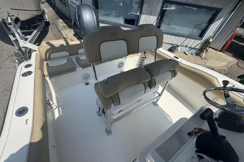 Slide: The Image of 2019 Key West 219fs boat interior with seating and steering wheel. - 11