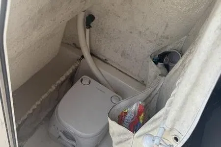 Slide: The Image of 2019 Key West 219fs boat interior with portable toilet and storage. - 13