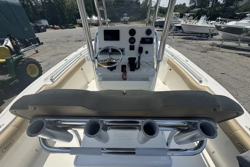 Slide: The Image of 2019 Key West 219fs boat interior with console, steering wheel, and rod holders. - 14