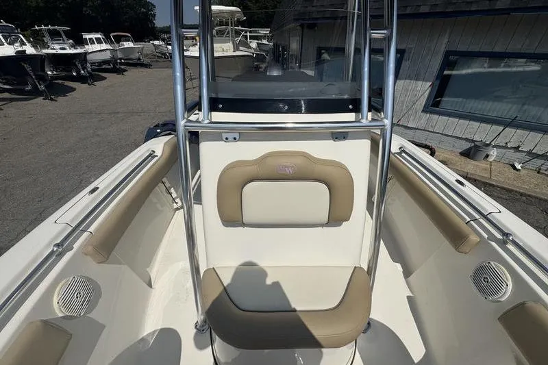 Slide: The Image of 2019 Key West 219fs boat interior with beige seating and stainless steel railings. - 4